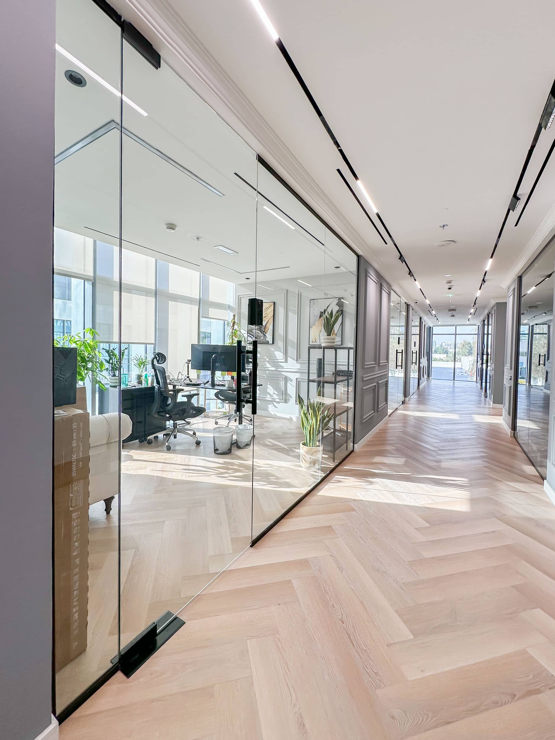 Bright and modern private office space at Oh My Desk Downtown Dubai, featuring glass partitions, sleek flooring, and ample natural light.